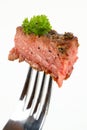 Medium grilled rumpsteak on a fork Royalty Free Stock Photo