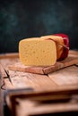 Medium hard cheese gouda edam on wooden board on sunlight table traditional table texture Royalty Free Stock Photo