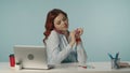 Medium isolated shot of a pleased and relaxed young woman file her nails whille talking on her phone and smiling. Royalty Free Stock Photo