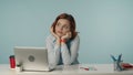 Medium isolated shot of a satisfied, happy and relaxed young woman looking away from the screen thinking, leaning on her