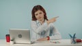 Medium isolated shot of a confused and dissatisfied young woman pointing her finger at something or someone off the Royalty Free Stock Photo