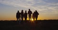 Friends together in the setting sun cheering