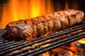 medium rare asado steak highlighted in grill flames