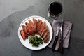 Medium rare beef steak on white plate, glass of red wine Royalty Free Stock Photo