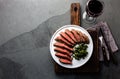 Medium rare beef steak on white plate, glass of red wine Royalty Free Stock Photo