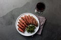 Medium rare beef steak on white plate, glass of red wine Royalty Free Stock Photo