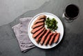 Medium rare beef steak on white plate, glass of red wine Royalty Free Stock Photo