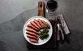 Medium rare beef steak on white plate, glass of red wine Royalty Free Stock Photo