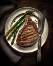 Medium Rare Grilled Tomahawk Beef Steak with Asparagus