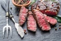 Medium rare Ribeye steak with herbs on graphite board Royalty Free Stock Photo