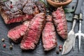 Medium rare Ribeye steak with herbs on graphite board Royalty Free Stock Photo