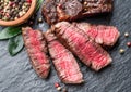 Medium rare Ribeye steak with herbs on graphite board Royalty Free Stock Photo