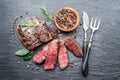 Medium rare Ribeye steak with herbs on graphite board Royalty Free Stock Photo