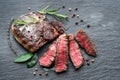 Medium rare Ribeye steak with herbs on graphite board Royalty Free Stock Photo