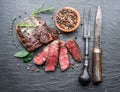 Medium rare Ribeye steak with herbs on graphite board Royalty Free Stock Photo