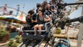 Medium shot of camera rig above roller coaster track capturing riders exhilarated expressions at a sudden steep drop Royalty Free Stock Photo