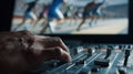 Medium shot capturing hands tweaking an advanced audio interface foreground sharp with blurred legacy sports footage Royalty Free Stock Photo