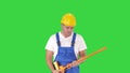 Cheerful man playing on the swob like it is a guitar on a Green Screen, Chroma Key.