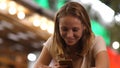 Cheerful woman at the bar reading funny messages on her mobile p Royalty Free Stock Photo