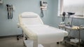 Medium shot of an exam table in a welllit medical room with diagnostic tools softly blurred in the background Royalty Free Stock Photo