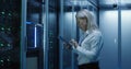 Female technician works on a tablet in a data center Royalty Free Stock Photo