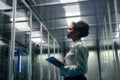 Female technician works on a tablet in a data center Royalty Free Stock Photo