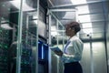 Female technician works on a tablet in a data center Royalty Free Stock Photo