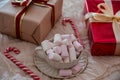 Medium View of Mug with Marshmallows and Christmas Gift Boxes Royalty Free Stock Photo