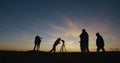 Friends stargazing together using a professional telescope