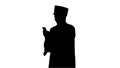 Silhouette Laughing male student in graduation gown and mortarbo