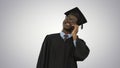 Smiling african american male student in graduation robe talking Royalty Free Stock Photo