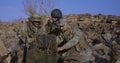 Armed soldiers looking at a computer