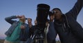 Friends stargazing together using a professional telescope Royalty Free Stock Photo