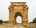 Medium shot of the iconic Arch of Septimius Severus at the ancient Roman ruins of Leptis Magna in Libya