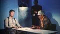 Medium shot of Interrogation room in smoke: detective showing evidence of drug trafficking to suspected black man Royalty Free Stock Photo