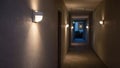 Medium shot of an LED motionsensor hallway light softly illuminating a corridor at dusk highlighting energyefficient Royalty Free Stock Photo