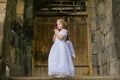 A medium shot of little armenian redhead girl praying in front of the door of armenian ancient monastery Royalty Free Stock Photo