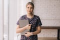 Medium shot portrait of attractive young woman office worker holding laptop computer in hands Royalty Free Stock Photo