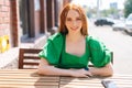 Medium shot portrait of happy smiling young woman sitting at table in outdoor cafe terrace in sunny summer day and Royalty Free Stock Photo