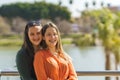 portrait of lesbian couple embracing and smiling at the camera