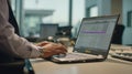 Medium shot of a professional accessing a secure digital case management system on a laptop highlighting cloudbased Royalty Free Stock Photo
