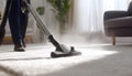 Medium shot of a professional using hot water extraction on a carpet lifting deepseated dirt and grime efficiently for a Royalty Free Stock Photo