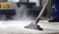 Medium shot of a professional using hot water extraction on a carpet lifting deepseated dirt and grime efficiently for a Royalty Free Stock Photo