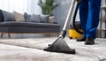 Medium shot of a professional using hot water extraction on a carpet lifting deepseated dirt and grime efficiently for a Royalty Free Stock Photo