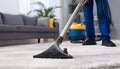 Medium shot of a professional using hot water extraction on a carpet lifting deepseated dirt and grime efficiently for a Royalty Free Stock Photo