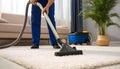 Medium shot of a professional using hot water extraction on a carpet lifting deepseated dirt and grime efficiently for a Royalty Free Stock Photo