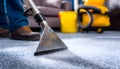 Medium shot of a professional using hot water extraction on a carpet lifting deepseated dirt and grime efficiently for a Royalty Free Stock Photo