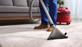 Medium shot of a professional using hot water extraction on a carpet lifting deepseated dirt and grime efficiently for a Royalty Free Stock Photo