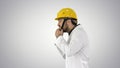 Engineer or Worker Yellow Safety Helmet Hat Putting on Head on gradient background.