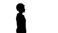 Silhouette Construction worker lady walking emotionless.